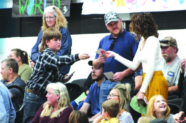 Brody Clark handed out 'thank you' cards to military veterans and their families during the Meridian Independent School District's all-band concert on Thursday, February 22, in the Meridian High School gymnasium. Nathan Diebenow | Meridian Tribune