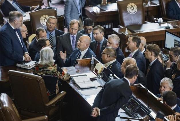 House Republicans crowded around the speaker's desk Tuesday to discuss a point of order attempting to strip absent members of their committee appointments. | Jordan Vonderhaar, Texas Tribune 