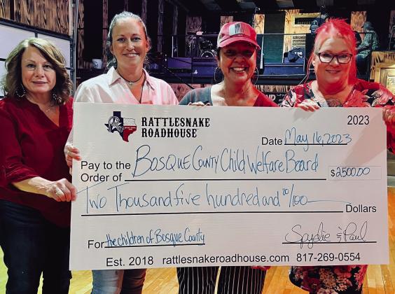 Represented by Kelly Olson (first, from left), Tiffany Gentry (second, from left), and Jonna LeGer (fourth, from left), the Bosque County Child Welfare Board recently raceived a donation from Laura Bush (third, from left), owner/operator of the Rattlesnake Ballroom and Roadhouse, raised from the 13th Annual Spydie Run and Crawfish Boil in Walnut Springs last month.