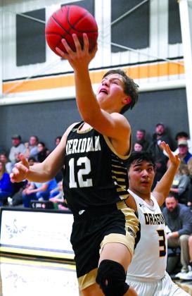 Jacket senior John Bernal (1) looks for a shot (left), sophomore Jordon Scheffer (12) drives the lane for a layup against Iredell as Meridian clinched the district title Photos by Wendy Orozco courtesy of Brett Voss’ The Sports Buzz