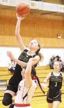 Lady Jacket senior Abby Edwards (14) looks for a shot (left), sophomore Journey Stauffer (5) with a layup (right). Photos by Wendy Orozco courtesy of Brett Voss’ The Sports Buzz