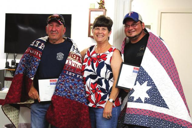 Debbie Stubbs (middle) presents Big Daniel Del Bosque (left) and Little Daniel Del Bosque (right) with Quilts of Valor for their service in the U.S. military. Ashley Barner | The Clifton Record