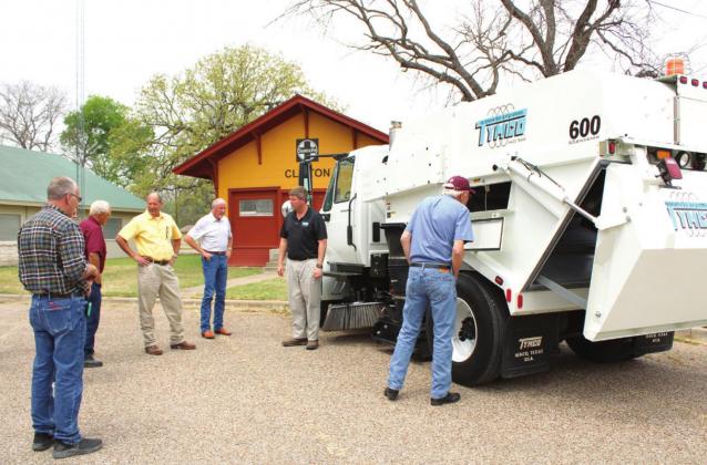Clifton city administration and council look over the new 2005 Tymco Model 600 regenerative air vacuum sweeper leased to own by the city. Brook DeZavala | The Clifton Record