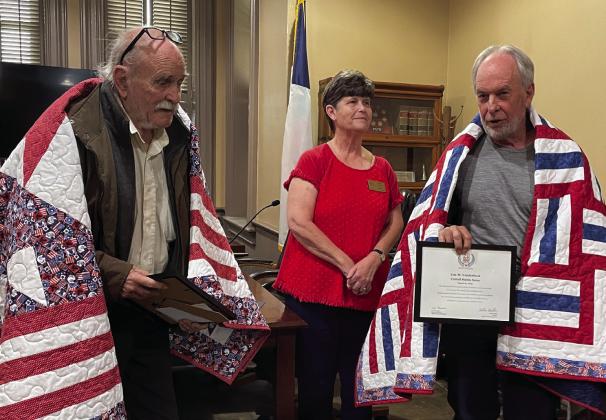 Debbie Stubbs (center) presented two Quilts of Valor to Vietnam War Veterans Frank Moorman, US Army, (left) and Eric Vanderbeck, US Army, (right) at the Bosque County Courthouse during a Vietnam War Veterans Day observance ceremony on Wednesday, March 29. Courtesy Photo By Bosque River Valley, NSDAR