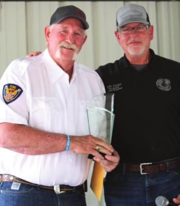 Iredell Fire Chief Bradley Fletcher is awarded the Fire Chief of the Year Award by Bosque County Fire Marshal Kirk Turner. Ashley Barner | The Clifton Record
