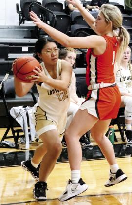 Lady Jacket junior Canyon Stauffer (4) makes a move for the layup (above right), junior Summer Chen (12) looks to pass the ball (top left), sophomore Journey Stauffer (5) drives the lane despite defensive pressure (above left). Photos by Wendy Orozco courtesy of Brett Voss’ The Sports Buzz