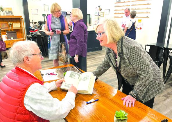 Betty Tindall (right) asked a question of Professor Gunnar Nerheim during a booksigning at the Tolstoy &amp; Co. Bookshop in historic downtown Clifton on Sunday, March 2. Nathan Diebenow | Meridian Tribune