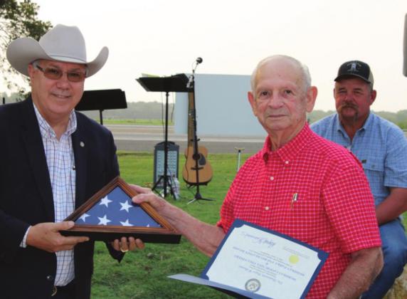 Field Agent for Congressman Roger Willams, Don Nicholas, presented Mayor Johnnie Hauerland and the city of Meridian with a flag and certificate commemorating the dedication of the John A. Lomax Amphitheater. Ashley Barner | Meridian Tribune