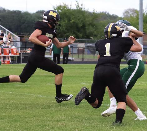 Brady Taylor takes out the opponent so his teammate can gain additional yards at their game Friday evening. Photo Courtesy of Brett Voss’ The Sports Buzz