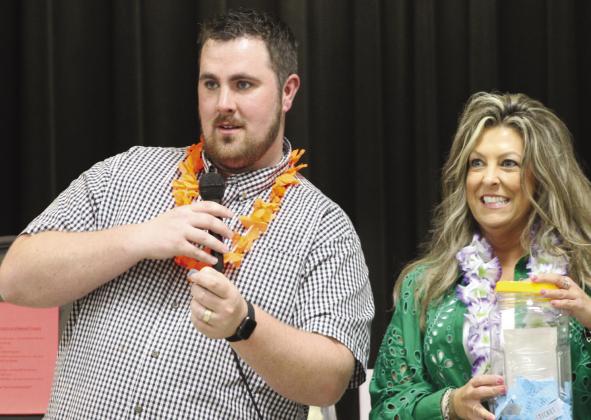 Talon Clift (from left) and Meridian Public Library board member Darci Allen team up to announce the winners of the stretch raffle during the Jewels and Jeans Fundraiser for the library at the Meridian Civic Center on Saturday night, April 20. Nathan Diebenow | Meridian Tribune