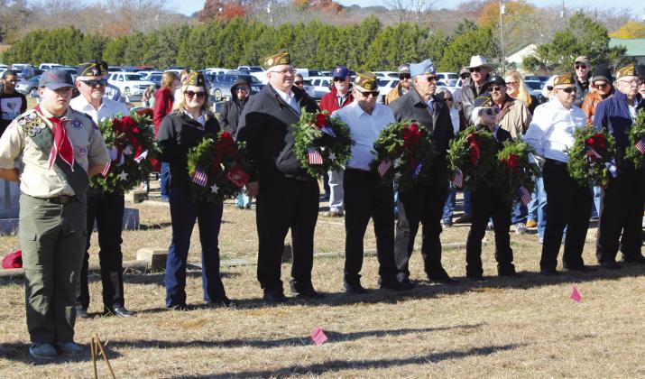 Members of the American Legion Post #322 and Veterans of Foreign Wars Post #8553 prepare to lay wreaths during the Wreaths Across America Ceremony in Clifton on Saturday, December 16. Nathan Diebenow | Meridian Tribune